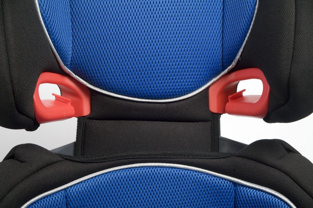 Close-up of a plastic slot guide on a booster seat